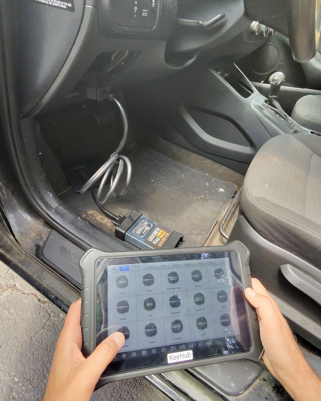 Alex, owner and technician at KeyHub LLC, selecting the vehicle on a key programming tablet