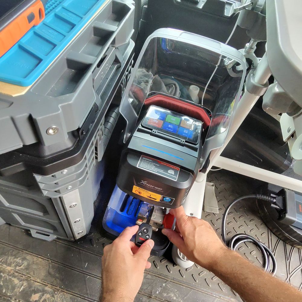 Cutting a new car key on the machine inside the KeyHub van